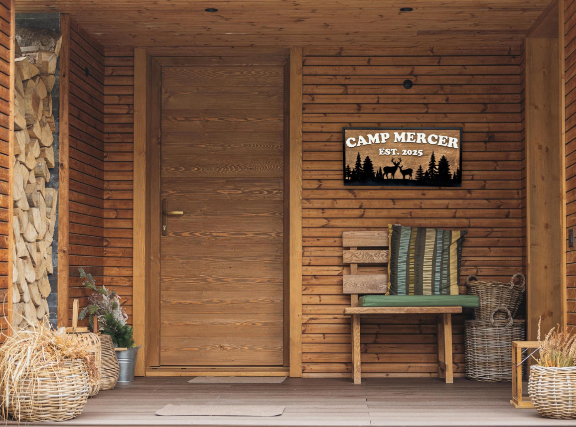 Wooden cabin exterior with 'Camp Mercer' sign on the wall