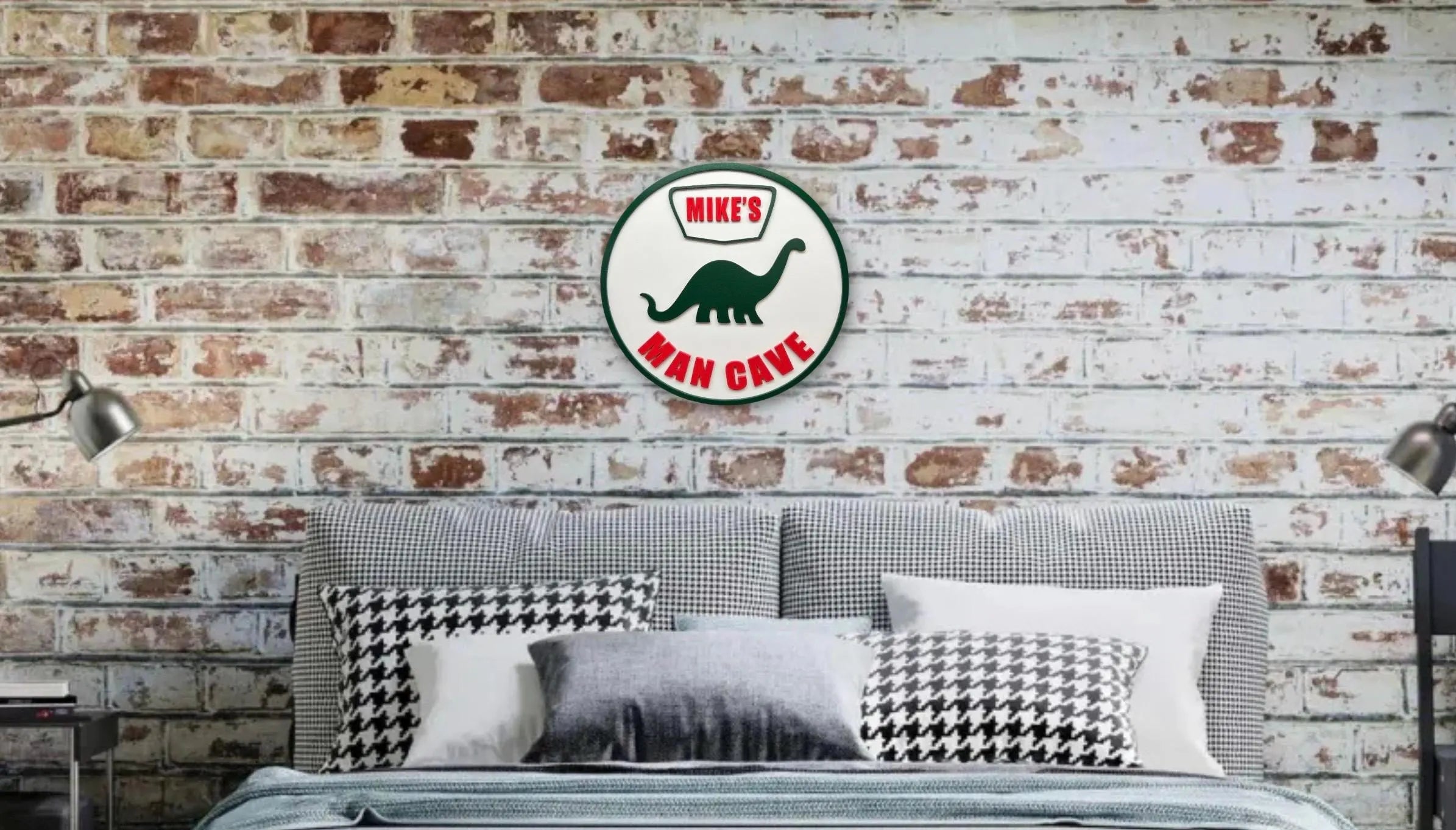 Gray sofa with decorative pillows against a brick wall with a 'Man Cave' sign.